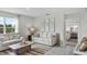 Inviting living room featuring neutral sofas, artwork, and a glimpse into the main bedroom at 2610 Grandbury Grove Rd, Lakeland, FL 33811