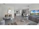 Open-concept living space with modern gray kitchen, dining area, and stylish furnishings at 2610 Grandbury Grove Rd, Lakeland, FL 33811