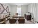 This office space features a desk and chairs, along with a decorative wooden wall and a carpeted floor at 2610 Grandbury Grove Rd, Lakeland, FL 33811
