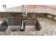 Kitchen sink with stainless steel dual basin and granite countertop at 2711 Eagle Creek Ct, Kissimmee, FL 34746