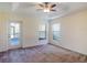 Spacious bedroom with tray ceiling, ceiling fan, and sliding door to outside at 27307 Pine Straw Rd, Leesburg, FL 34748