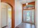 Welcoming foyer with a decorative glass front door and tiled floor, offering a view into the living area at 27307 Pine Straw Rd, Leesburg, FL 34748