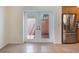 Bright kitchen area with stainless steel refrigerator and access to the outside at 27307 Pine Straw Rd, Leesburg, FL 34748