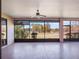 Screened lanai overlooking a peaceful lake with large sliding glass doors at 27307 Pine Straw Rd, Leesburg, FL 34748
