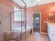 Main bathroom with large soaking tub, tile surround, and separate glass-enclosed shower at 27307 Pine Straw Rd, Leesburg, FL 34748