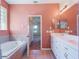 Spacious main bathroom with dual sink vanity and a soaking tub at 27307 Pine Straw Rd, Leesburg, FL 34748