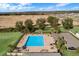 Aerial view of a community pool with lounge chairs and cabana area surrounded by lush landscaping at 27307 Pine Straw Rd, Leesburg, FL 34748