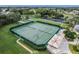 Aerial view of the community's green tennis courts with covered seating at 27307 Pine Straw Rd, Leesburg, FL 34748