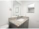 Bathroom vanity with granite countertop, modern faucet, and decorative framed mirror at 3057 Aaron Burr Ave # 1, Winter Park, FL 32792