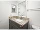 Bathroom features a vanity with a gray cabinet and stone-look countertop and a rectangular mirror at 3057 Aaron Burr Ave # 1, Winter Park, FL 32792