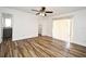 Spacious bedroom features wood-look floors and sliding glass doors leading to a balcony at 3057 Aaron Burr Ave # 1, Winter Park, FL 32792