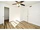 This bedroom features wood-look flooring, a ceiling fan, and a closet at 3057 Aaron Burr Ave # 1, Winter Park, FL 32792