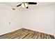 Bright bedroom features wood-look floors, a ceiling fan, and freshly painted white walls at 3057 Aaron Burr Ave # 1, Winter Park, FL 32792