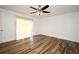 Spacious bedroom features wood-look floors and sliding glass doors leading to a balcony at 3057 Aaron Burr Ave # 1, Winter Park, FL 32792