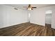 Neutral-toned bedroom with wood-look floors, ceiling fan, and large closet at 3057 Aaron Burr Ave # 1, Winter Park, FL 32792