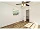 Bright bedroom features wood-look flooring, ceiling fan, and closet at 3057 Aaron Burr Ave # 1, Winter Park, FL 32792