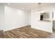 Bright dining room with wood-look tile flooring and view to kitchen via pass-through window at 3057 Aaron Burr Ave # 1, Winter Park, FL 32792
