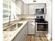 Updated kitchen features stainless steel range and microwave, granite countertops, and gray cabinets at 3057 Aaron Burr Ave # 1, Winter Park, FL 32792