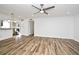 Open-concept living room featuring tile floors and a view into the kitchen with stainless steel appliances at 3057 Aaron Burr Ave # 1, Winter Park, FL 32792