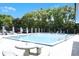 Community pool surrounded by greenery and seating, perfect for relaxation and recreation at 3057 Aaron Burr Ave # 1, Winter Park, FL 32792