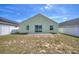 A cozy backyard with patio, privacy fence, and lawn leading up to the home at 326 Cotswold Cir, Davenport, FL 33837