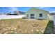 Spacious backyard featuring white fencing, a patio, and minimal landscaping at 326 Cotswold Cir, Davenport, FL 33837