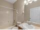 Bathroom featuring a sink, bathtub, mirror and tile flooring at 326 Cotswold Cir, Davenport, FL 33837