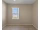 Vacant room featuring a window offering natural light and tiled flooring at 326 Cotswold Cir, Davenport, FL 33837