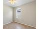 A clean bedroom with neutral paint, tile floor, a ceiling fan and natural light at 326 Cotswold Cir, Davenport, FL 33837