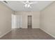 Neutrally painted bedroom featuring tiled floors, a ceiling fan, and closet at 326 Cotswold Cir, Davenport, FL 33837