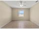 Spacious bedroom with neutral walls, tiled floors, and a ceiling fan at 326 Cotswold Cir, Davenport, FL 33837