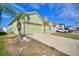 Lovely one-story home with a well-manicured lawn, two-car garage, and a light green exterior at 326 Cotswold Cir, Davenport, FL 33837