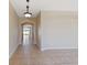Hallway with tile floors, archways, and views into other rooms, creating an inviting atmosphere at 326 Cotswold Cir, Davenport, FL 33837