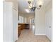 Bright kitchen with wood cabinets, tile flooring, and modern lighting fixture at 326 Cotswold Cir, Davenport, FL 33837