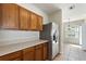 Functional kitchen featuring wooden cabinets, stainless steel refrigerator, and tile floors at 326 Cotswold Cir, Davenport, FL 33837