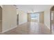 Large living room with tile flooring, a ceiling fan, and a sliding glass door to the backyard at 326 Cotswold Cir, Davenport, FL 33837