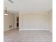 A spacious living room with tile flooring, neutral walls, and an arched accent wall at 326 Cotswold Cir, Davenport, FL 33837