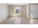 Bright, open-concept living room featuring tile floors, a large window, and a neutral color palette at 326 Cotswold Cir, Davenport, FL 33837