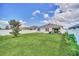 Spacious backyard features a well-manicured lawn, white fence, and inviting covered patio at 3308 Country Walk Club Cir, Winter Haven, FL 33881