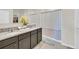 Bathroom features a double vanity with granite countertops and a shower with a decorative curtain at 3308 Country Walk Club Cir, Winter Haven, FL 33881