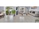 Comfortable living room features sliding glass doors to the patio, tile flooring, and stylish neutral decor at 3308 Country Walk Club Cir, Winter Haven, FL 33881