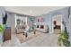 Cozy living room featuring tile floors, modern decor, natural light, and an open doorway to the Primary bedroom at 3308 Country Walk Club Cir, Winter Haven, FL 33881