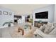 Spacious open-concept layout connecting the living room and kitchen featuring tile flooring and modern decor at 3308 Country Walk Club Cir, Winter Haven, FL 33881