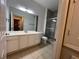 Bathroom featuring shower with glass door, tile floors and long vanity at 3332 Robert Trent Jones Dr # 10703, Orlando, FL 32835