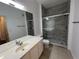 The updated bathroom offers an oversized mirror, shower with gray tile and a vanity at 3332 Robert Trent Jones Dr # 10703, Orlando, FL 32835