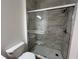 Bathroom featuring shower with glass door and decorative tile at 3332 Robert Trent Jones Dr # 10703, Orlando, FL 32835