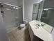 The bathroom includes tile flooring, a shower with a glass door, and a single sink vanity at 3332 Robert Trent Jones Dr # 10703, Orlando, FL 32835