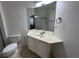Bathroom featuring a toilet, vanity and shower with sliding doors at 3332 Robert Trent Jones Dr # 10703, Orlando, FL 32835