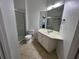 The bathroom features tile flooring, a vanity with a sink, and a glass-enclosed shower at 3332 Robert Trent Jones Dr # 10703, Orlando, FL 32835