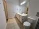 Bathroom featuring a large mirror, single sink vanity and tile floors at 3332 Robert Trent Jones Dr # 10703, Orlando, FL 32835
